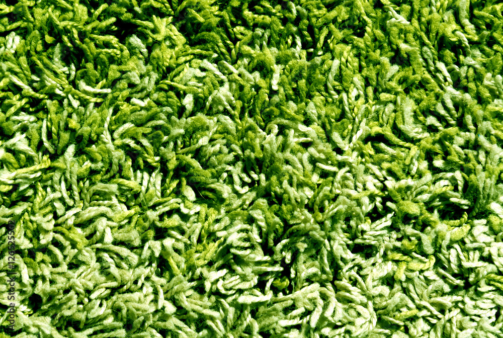 Green and beige color carpet surface.