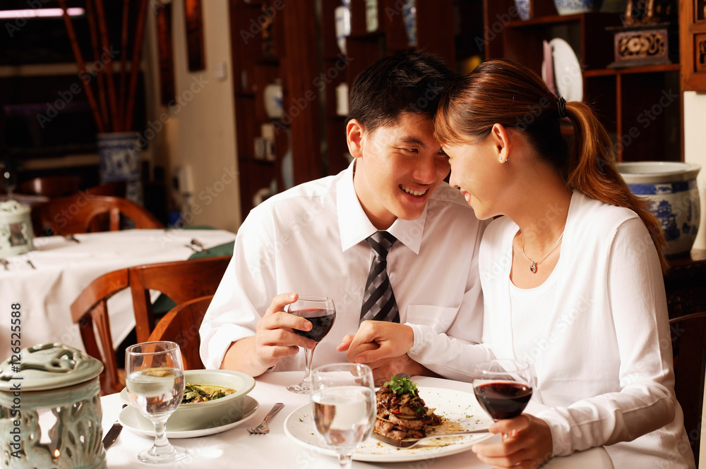 Couple in restaurant, sitting face to face