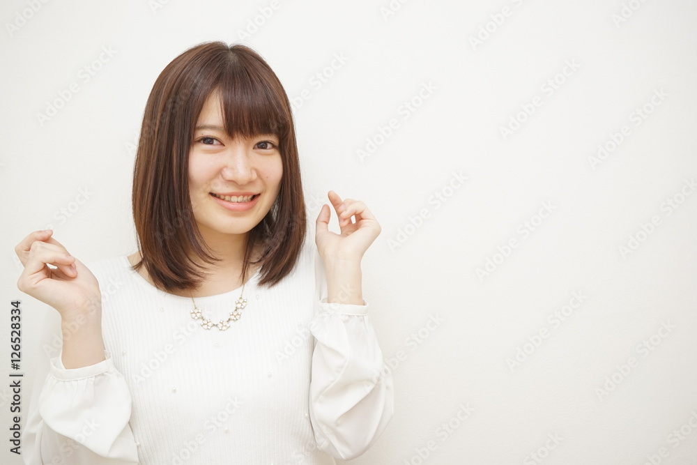 Young woman treating her hair on the white background Young woman treating her hair on the white background