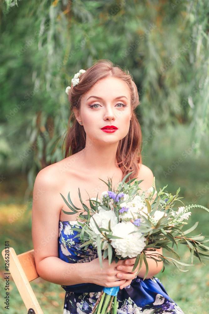 beautiful young woman with a bouquet of flowers in their hands beautiful young woman with a bouquet of flowers in their hands