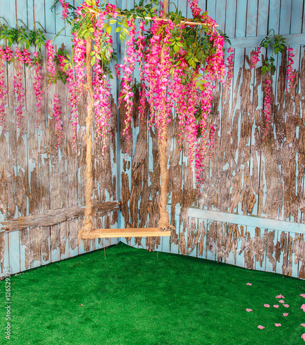Fototapeta Naklejka Na Ścianę i Meble -  Empty swings in flowers