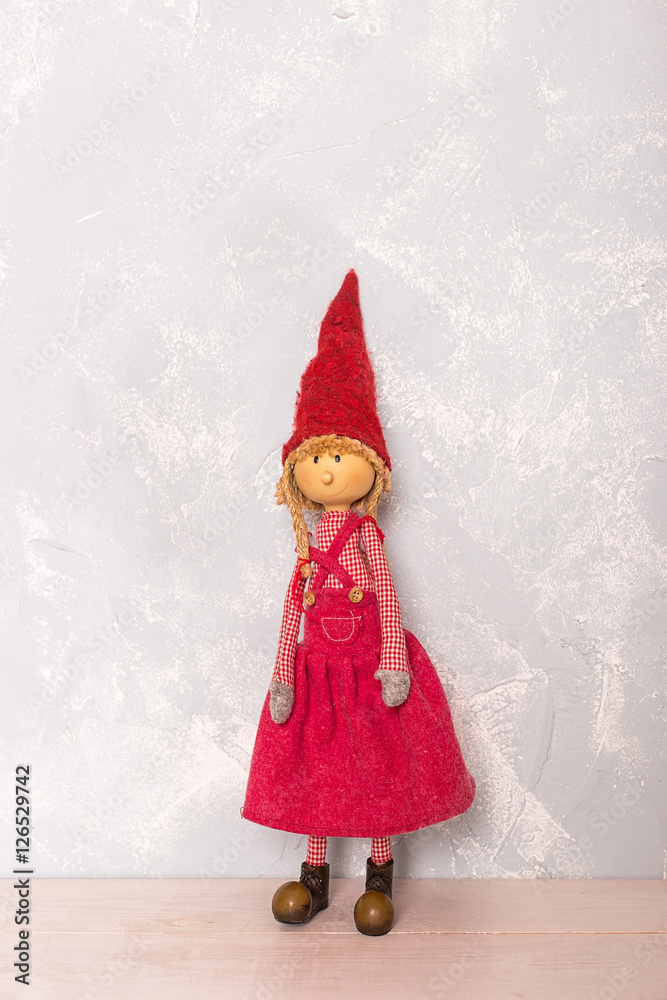 toy red doll girl on the wooden floor