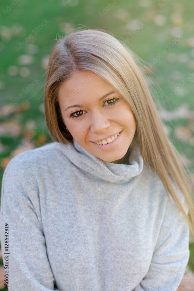 Pretty blonde girl at autumn