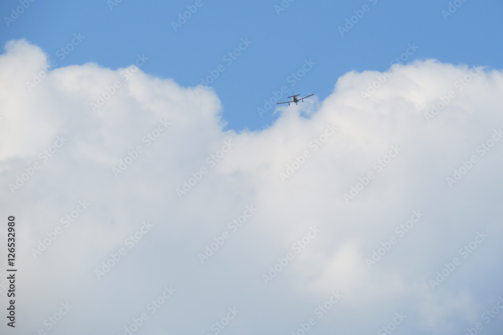 Small airplane passing in a fluffy cloud. Small airplane passing in a fluffy cloud.