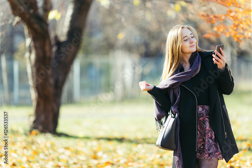 Blonde woman walking in the park background