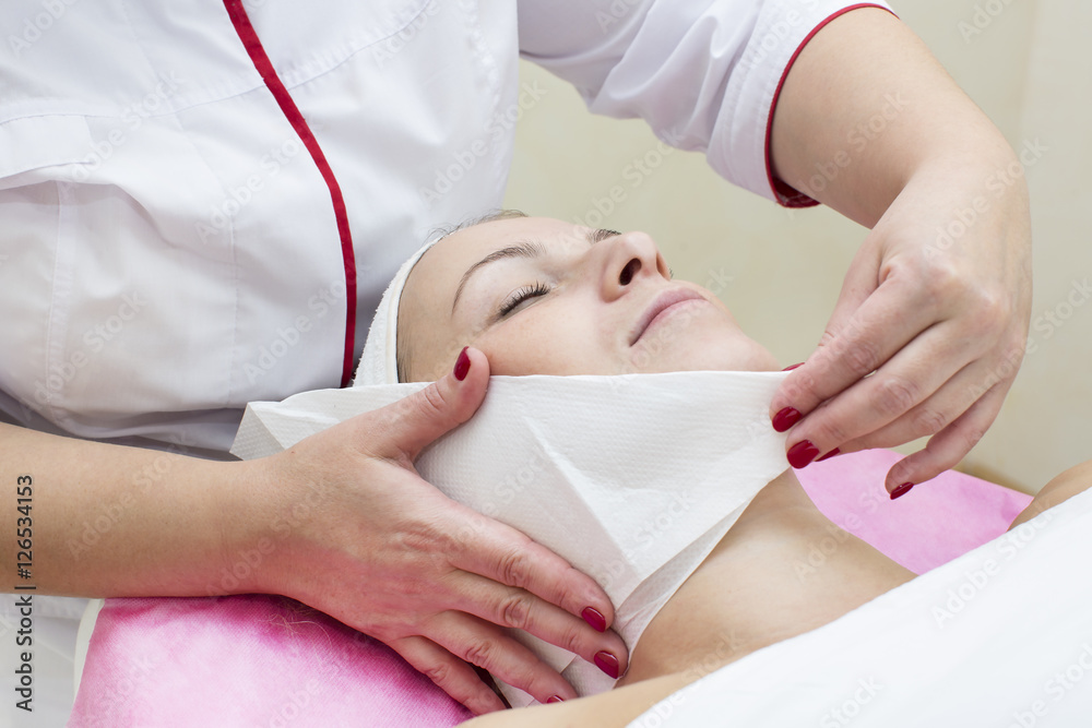 Naklejka premium Process of massage and facials in beauty salon