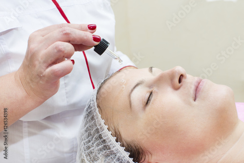 Process of massage and facials in beauty salon photo