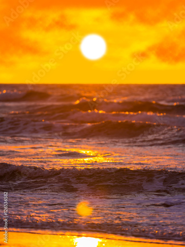sea waves on the sunset background © Olexandr