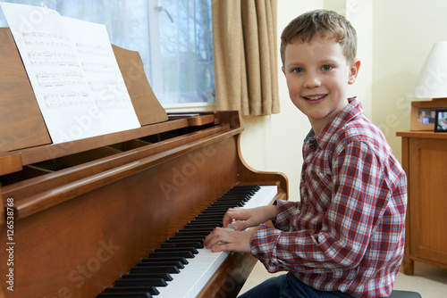 Portrait Of Young Boy Playing Piano At Home