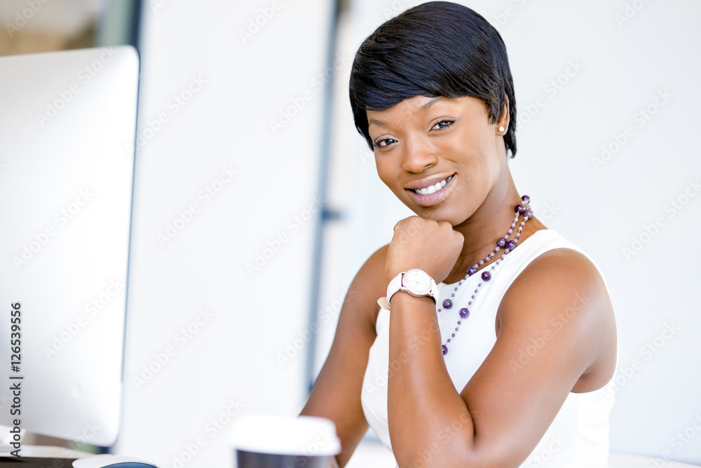 Portrait of businesswoman working at her desk in office Portrait of businesswoman working at her desk in office
