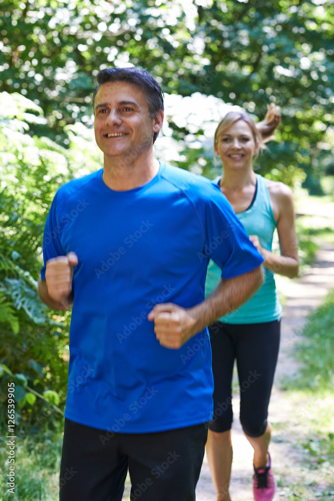 Mature Couple Running In Countryside Mature Couple Running In Countryside
