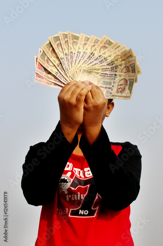 9th November, 2016, India- A unidentified boy took some Indian currency in the air. Now these currencies are invalid. Waiting for rebirth.