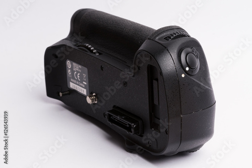 Battery grip for DSLR cameras isolated on white background.