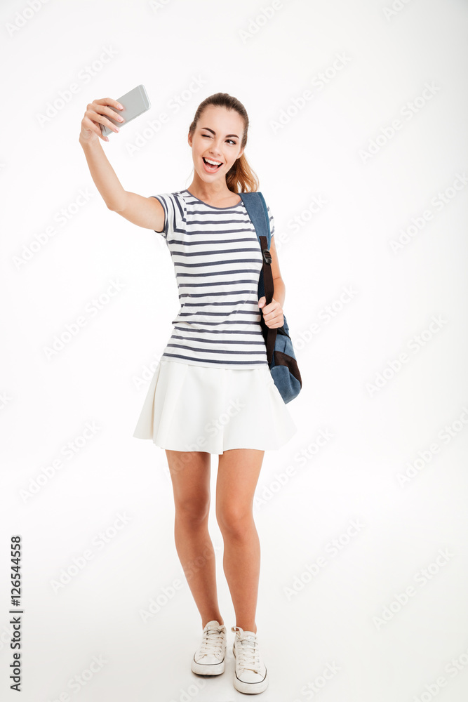 Happy woman student making selfie photo on smartphone Happy woman student making selfie photo on smartphone