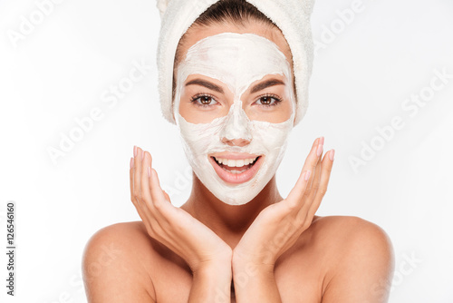 Konstfotografi Beautiful smiling woman with white clay facial mask on face