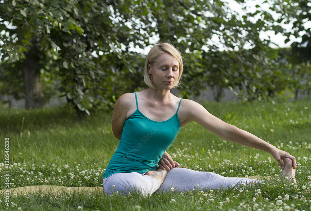 Flexible young woman practicing yoga outdoors Flexible young woman practicing yoga outdoors