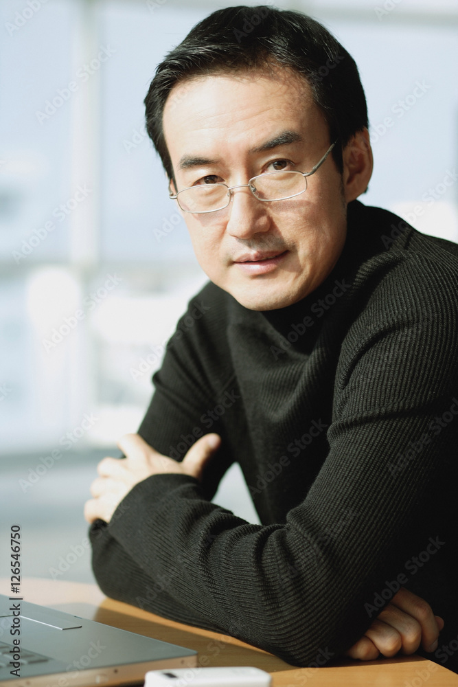 Man looking at camera, arms crossed, portrait Man looking at camera, arms crossed, portrait