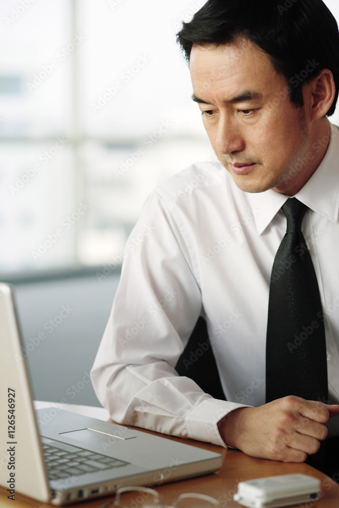Businessman looking at laptop Businessman looking at laptop