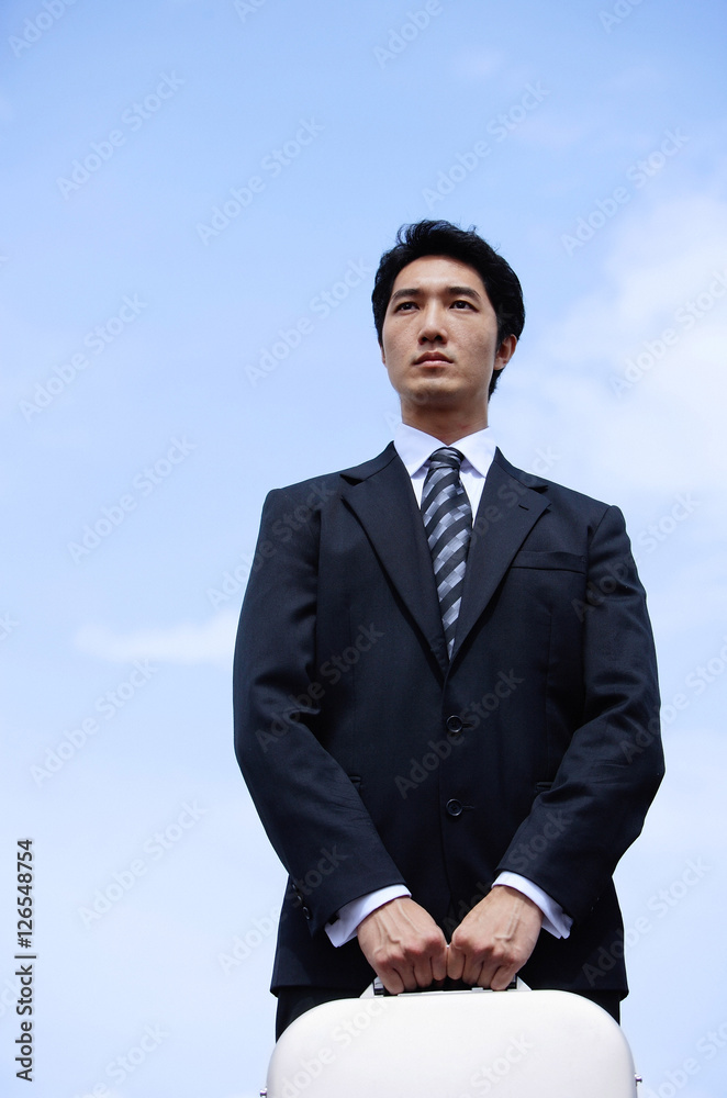 Businessman carrying briefcase, looking away Businessman carrying briefcase, looking away