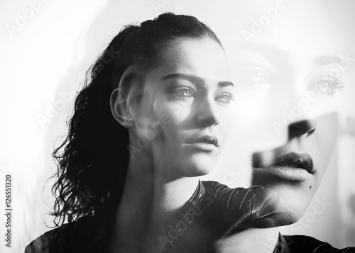 Monochrome double exposure of girl with gorgeous eyes looking aside