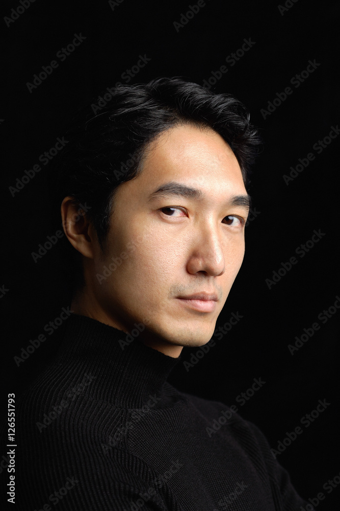 Man looking at camera, black background