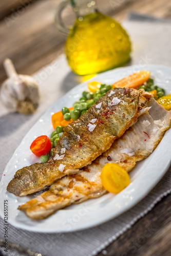 Grilled fish fillets  with   vegetables on plate
