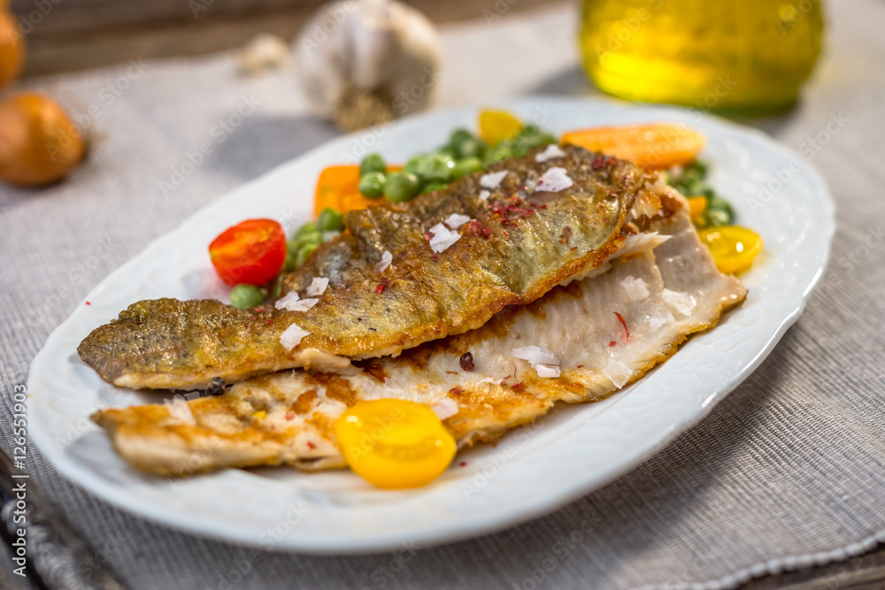 Grilled fish fillets with vegetables on plate Grilled fish fillets with vegetables on plate