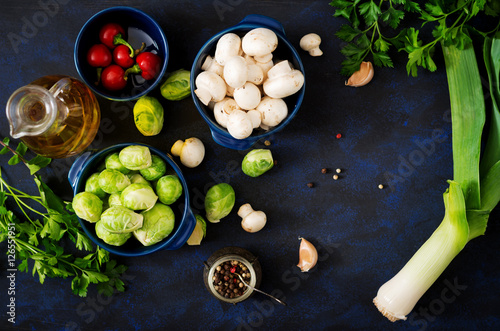Dietary menu. Ingredients: Vegetables - Brussels sprouts, mushrooms, leeks and herbs on a dark background. Top view. Vegetables menu.