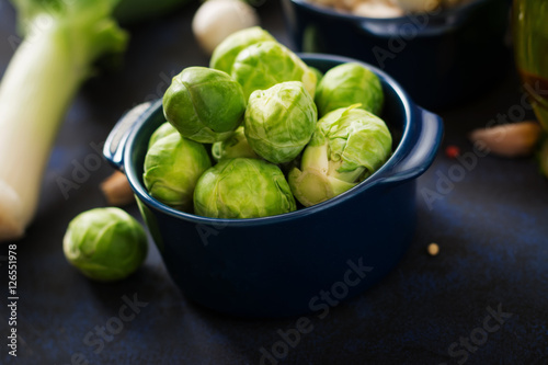Fotografie Fresh Brussels sprouts in bowl on a dark background