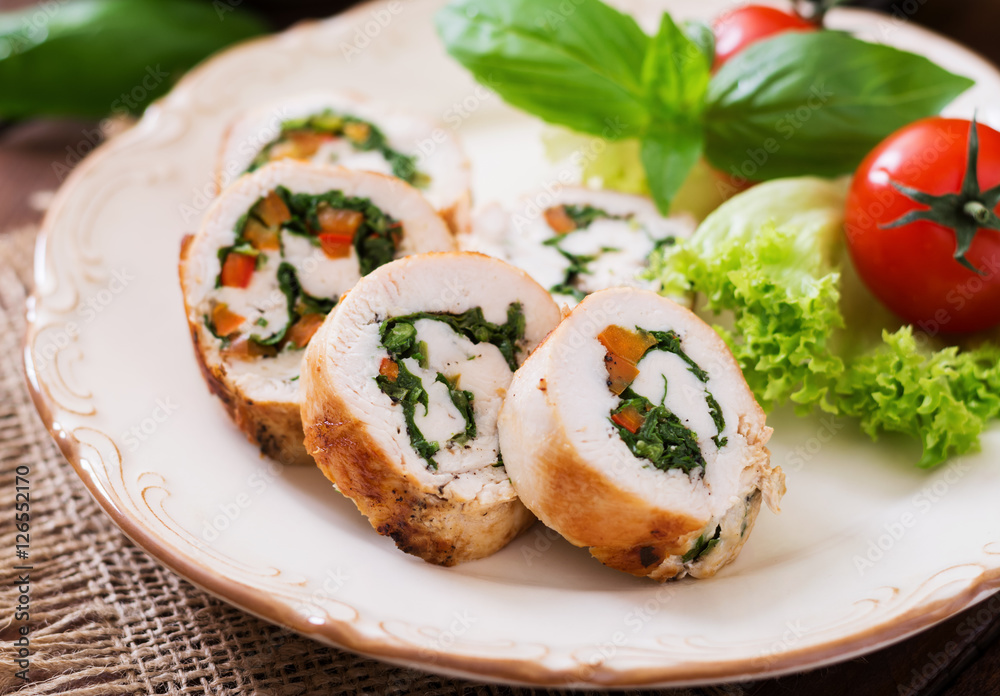 Chicken rolls with greens, garnished with salad.