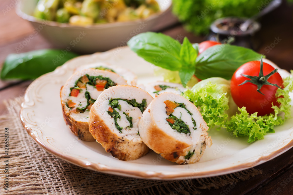 Chicken rolls with greens, garnished with salad. Chicken rolls with greens, garnished with salad.