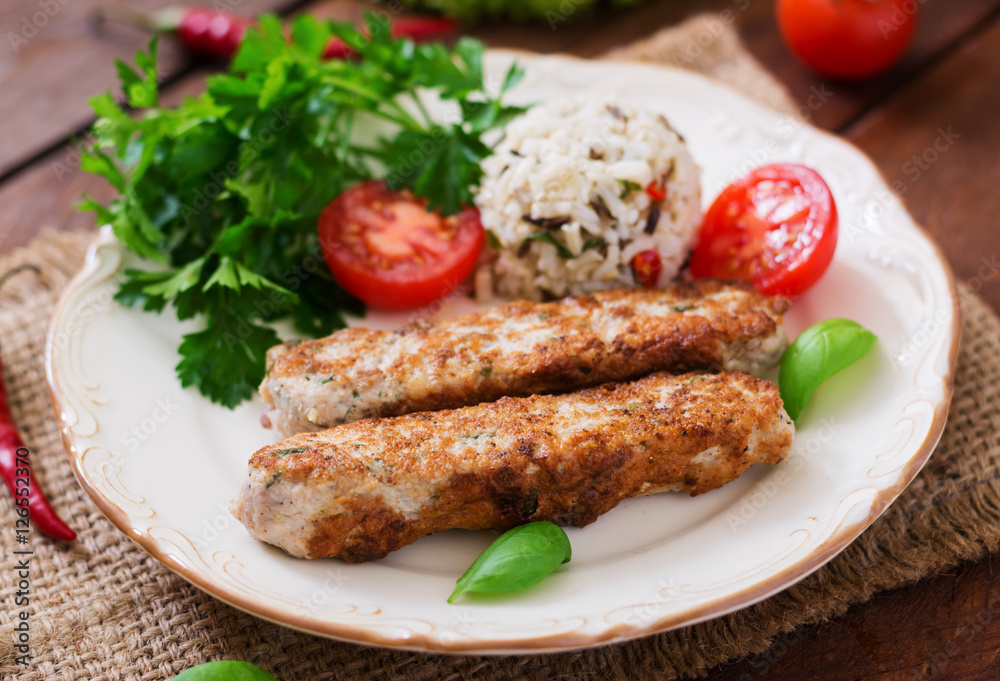 Minced Lula kebab grilled turkey (chicken) with rice and tomato.