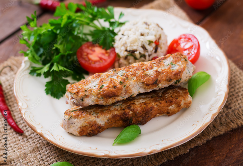Minced Lula kebab grilled turkey (chicken) with rice and tomato. Minced Lula kebab grilled turkey (chicken) with rice and tomato.