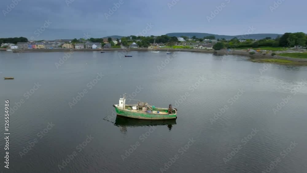 The big ship in the middle in the sea in West Ireland it is like and old rusty big ship and seen the aerial shot of the village The big ship in the middle in the sea in West Ireland it is like and old rusty big ship and seen the aerial shot of the village