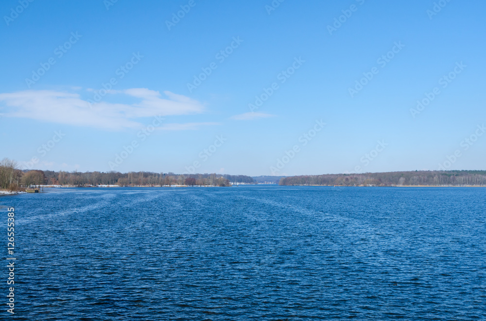 Deep blue horizon over winter river or lake surface