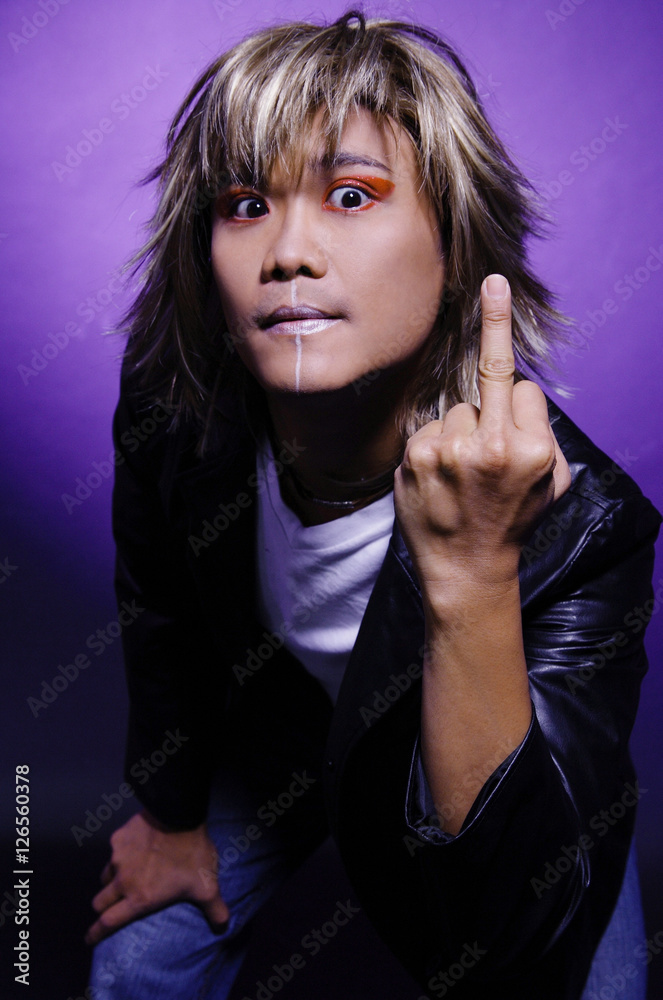 Man in leather jacket and face paint, making rude hand gesture Man in leather jacket and face paint, making rude hand gesture
