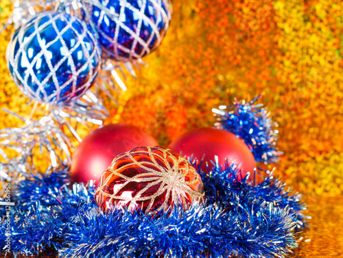 Blue tinsel and christmas balls on gold background