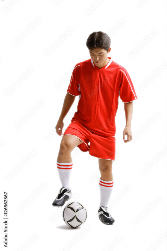Young man in soccer uniform with soccer ball