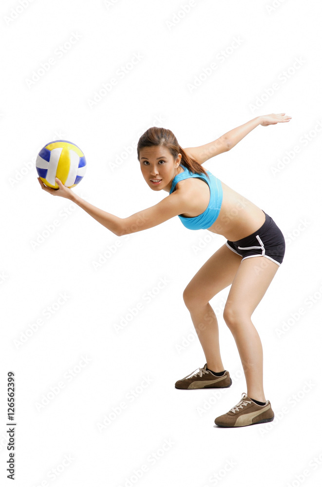 Young woman preparing to hit volleyball