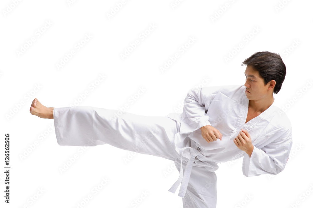 Young man in martial arts uniform, kicking Young man in martial arts uniform, kicking