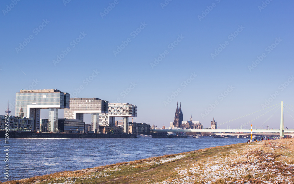 Panoramic view of cologne during winter season. Crane houses, cathedral, bridge and television tower.
