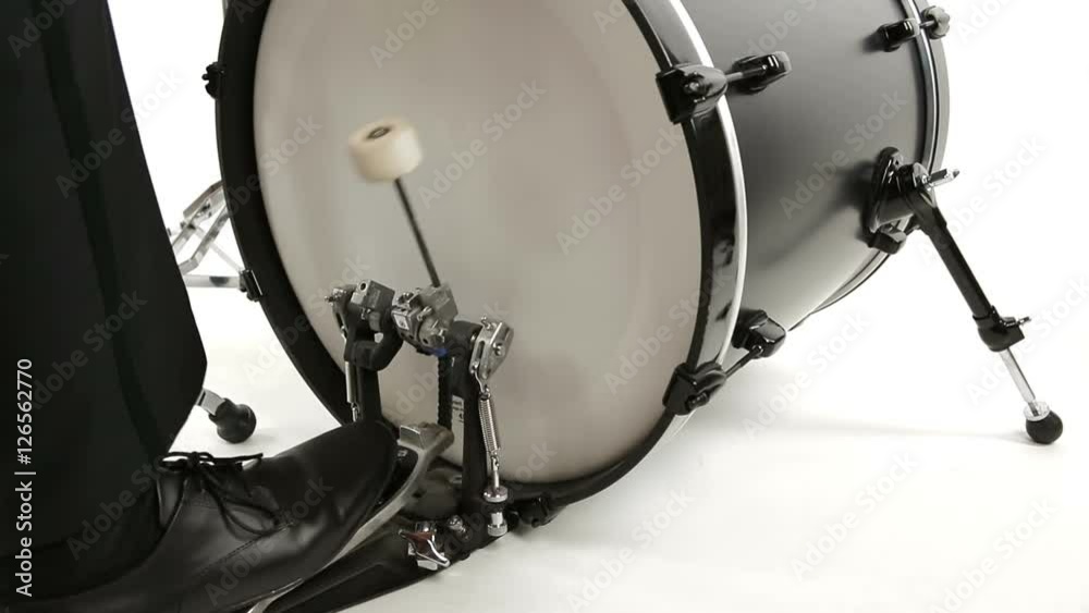 musician in tuxedo playing bass drum isolated on white background