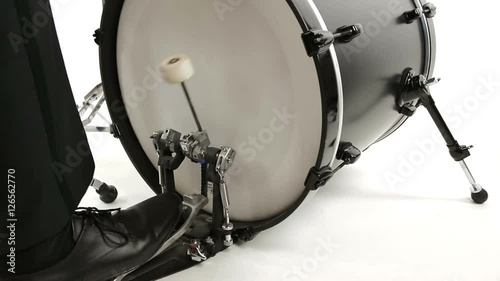 musician in tuxedo playing bass drum isolated on white background