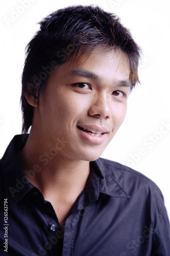 Young man smiling at camera, head shot © Alexander