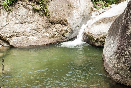 Natural water pond between large stones