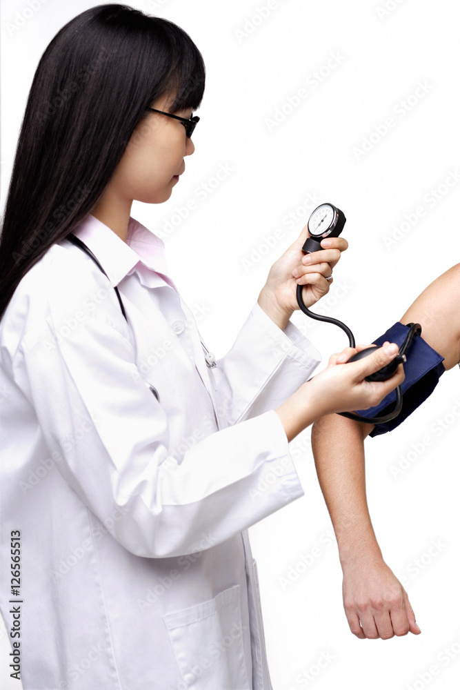Female doctor checking blood pressure of patient