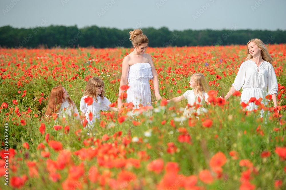 family with friends in red poppy field family with friends in red poppy field