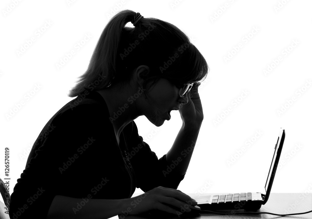 silhouette of a woman shocked by prices that she saw on a computer