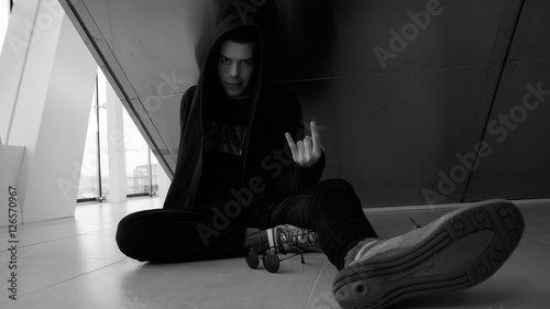 The young modern guy in a black robe with a hood