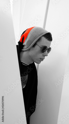 The young modern guy in a black robe with a hood